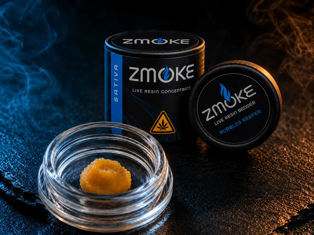 ZMOKE live resin badder in an open glass jar beside its labeled tin